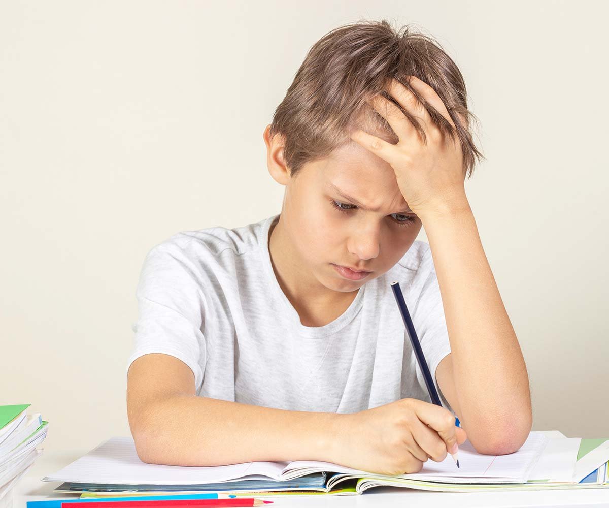 Student writing with pencil