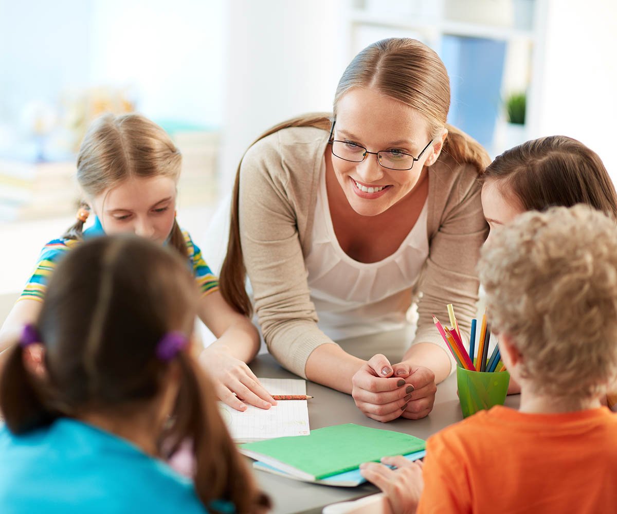 Smiling teacher with students