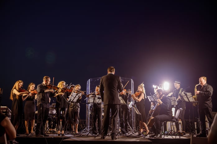 orchestra-performing-on-stage-at-night-2026-03-24-22-02-14-utc